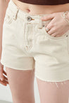 Detail shot of Ruhe Ecru Denim Shorts, highlighting fabric texture and finish