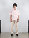 Man wearing pink Biasca Bowling Shirt, showcasing relaxed, boxy fit in premium Swiss cotton.