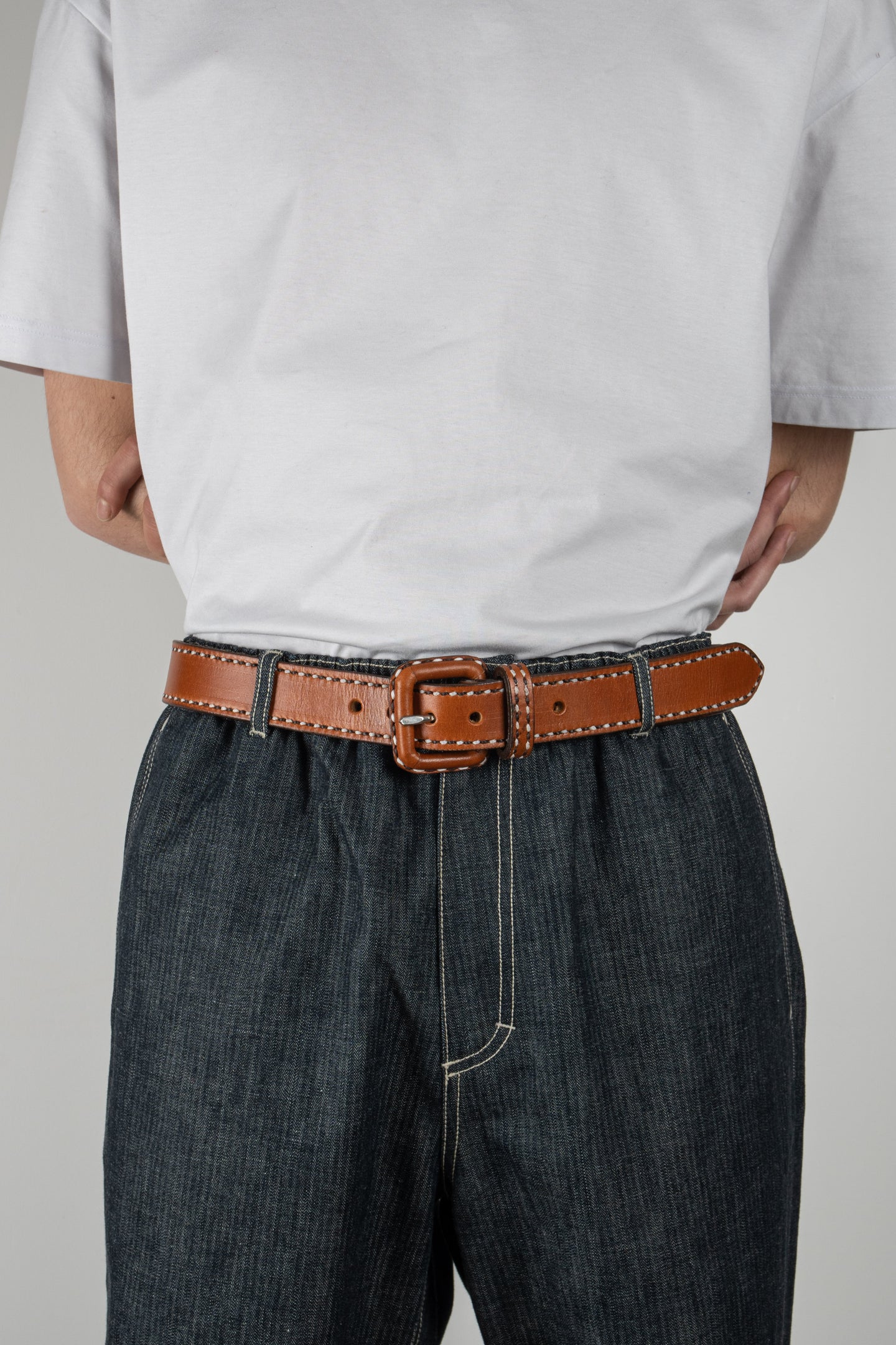 Men wearing handmade brown Charro Leather Belt with raw denim jeans