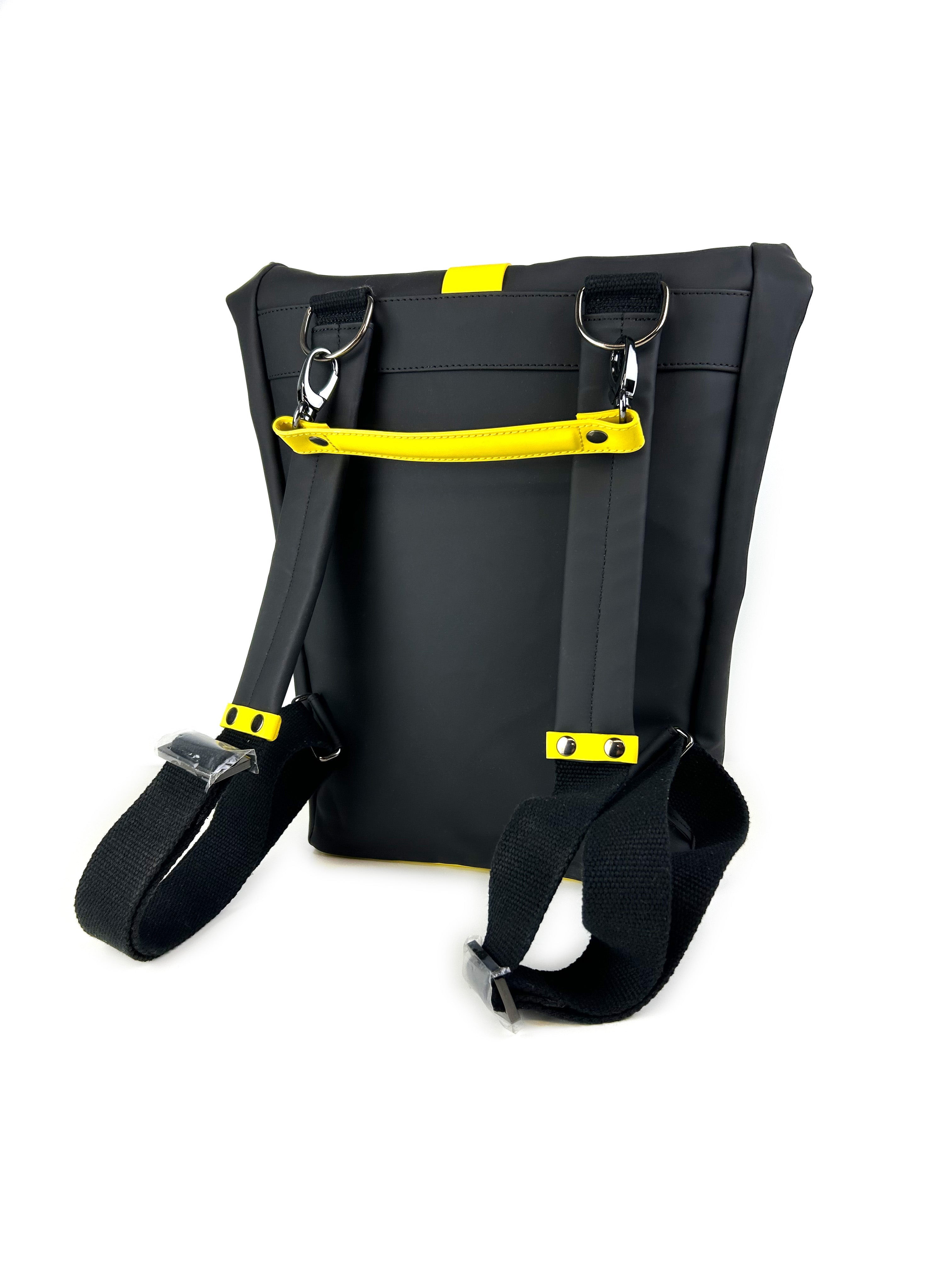 Reverse side of HADLEY Waterproof Backpack in black showing padded leather shoulder straps and contrasting yellow details 