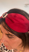 Woman with brown hair wearing chic red headband 