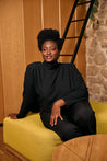 Stylish black woman wearing the Jane black wool crepe blouse