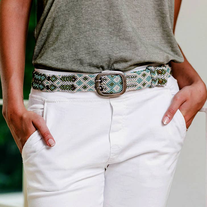 Woman wears Smitten Adriana Handwoven Ocean Belt in soft off-white, turquoise, and light olive with intricate weaving patterns now at 99things.ch