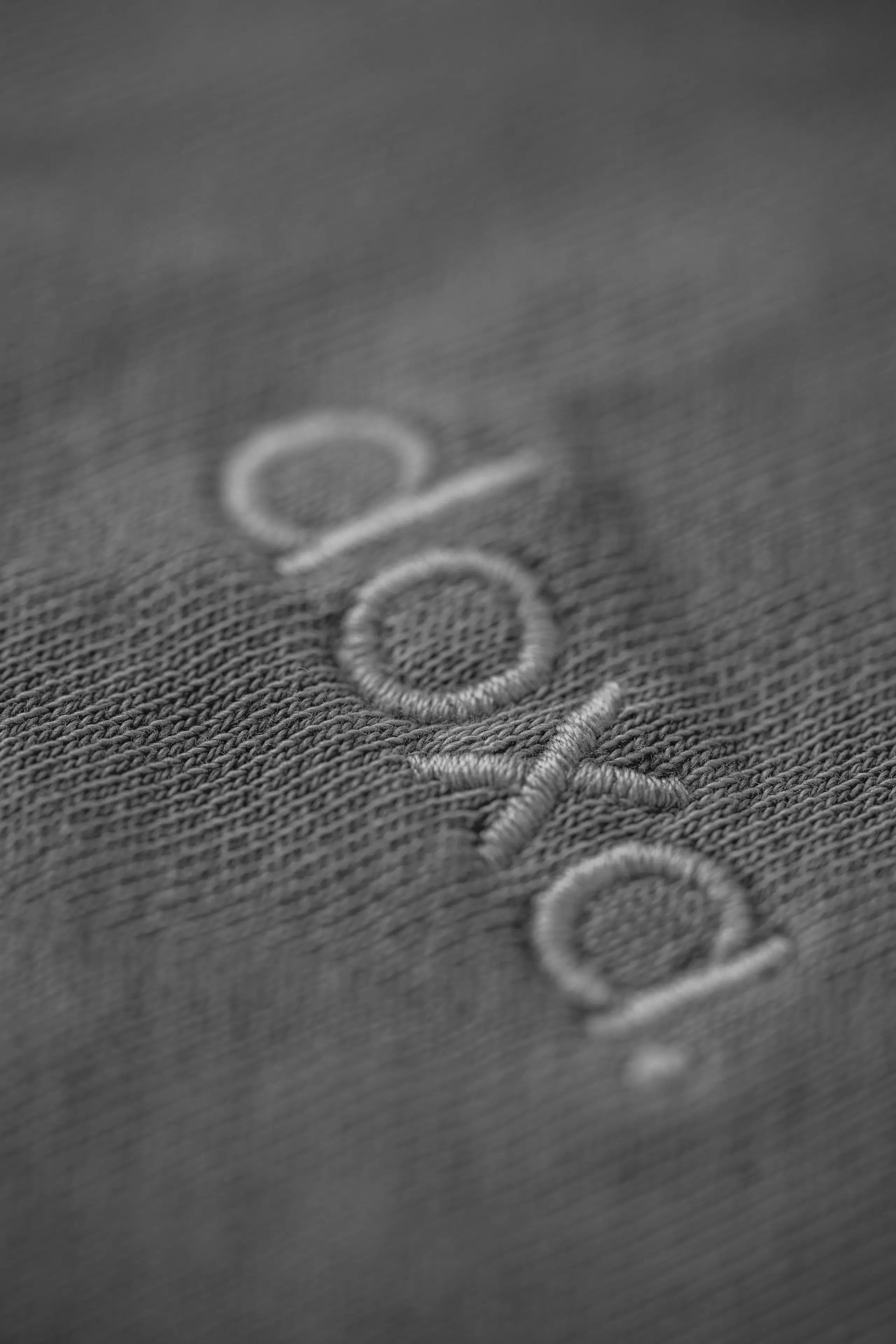 a close up view of a the woven logo of French sustainable fashion brand DOXA