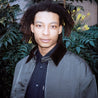 Stylish young man in his 20s wearing a vintage-inspired flight jacket with a corduroy collar, exuding effortless cool