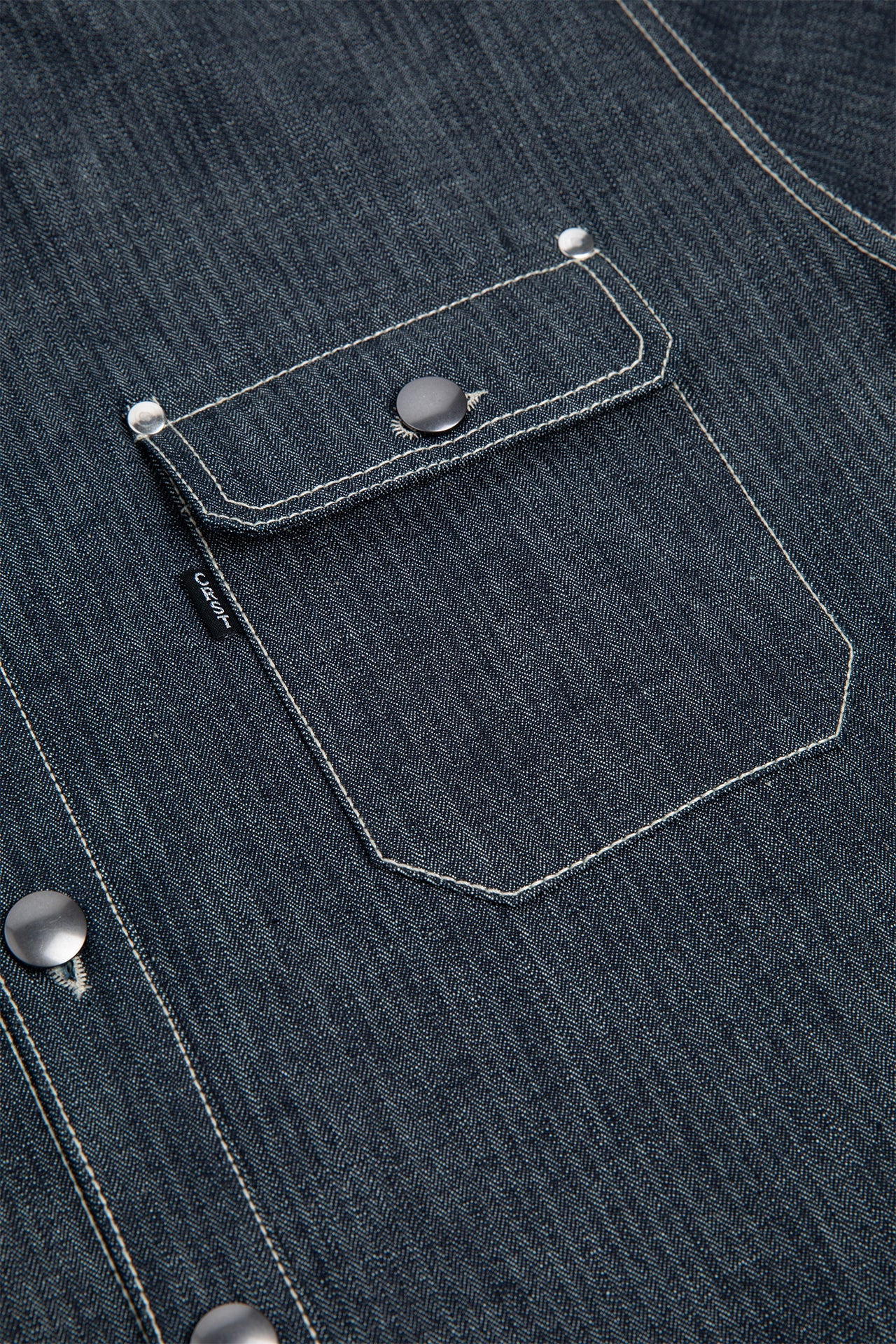 Detail Shot of Chest Patch Pockets with Flaps and signature white stitching.