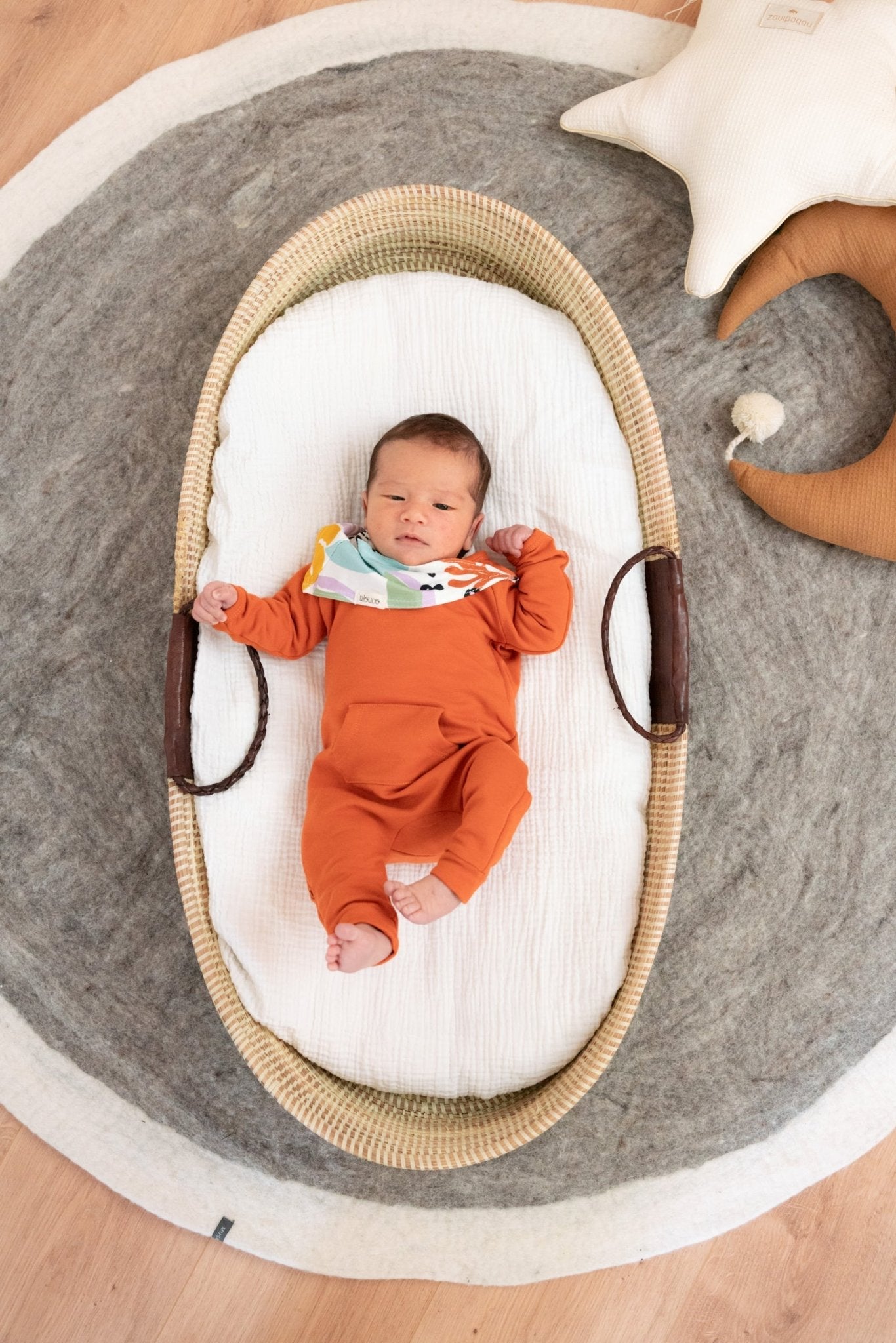 A baby wearing Tilouco's tropical bandana for little ones.